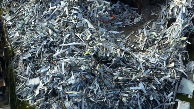Beg pile of scrap aluminum metal siding from ruined houses after hurricane Ian swept through Florida. Recycle of broken parts of mobile homes