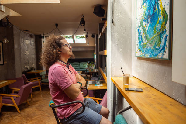 istock Observing a painting at a local cafe 1612536186