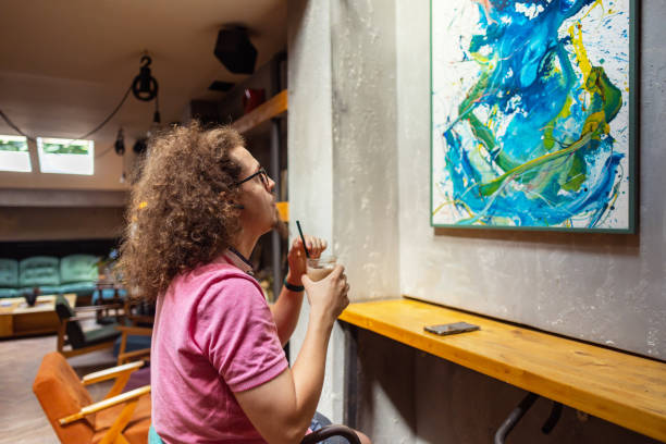 istock Observing a painting at a local cafe 1612536188