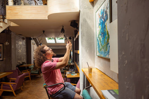 istock Observing a painting at a local cafe 1612540830