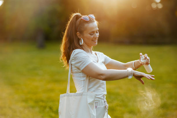 happy elegant woman in white shirt with tote bag and spf stock photo