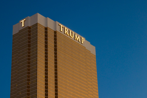 Las Vegas, NV - November 24, 2021: View of the beautiful Flamingo Hotel and Casino sign, beyond palm trees, on Las Vegas Boulevard.