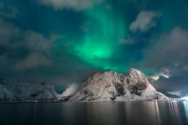 istock Strong Aurora borealis dancing behind and over mountains on Lofoten islands 1612566744