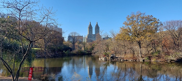 This image shows a view of Central Park in NYC with the Dakota building in the background.