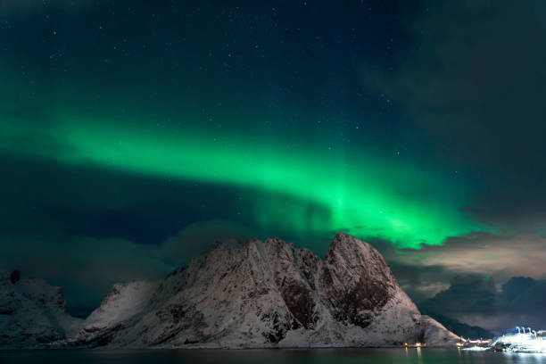 istock Strong Aurora borealis dancing behind and over mountains on Lofoten islands 1612566812