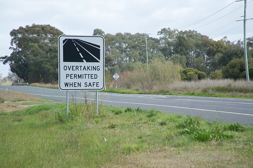 Road sign on a major country road, indication that overtaking slower moving vehicles is permitted when it is safe do so