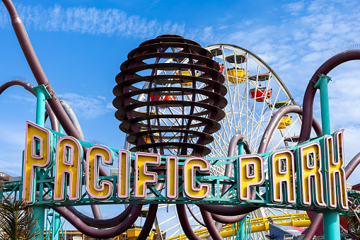 Pacific Park Amusement Park neon sign and ferris wheel at the Santa Monica pier in Santa Monica, CA, USA