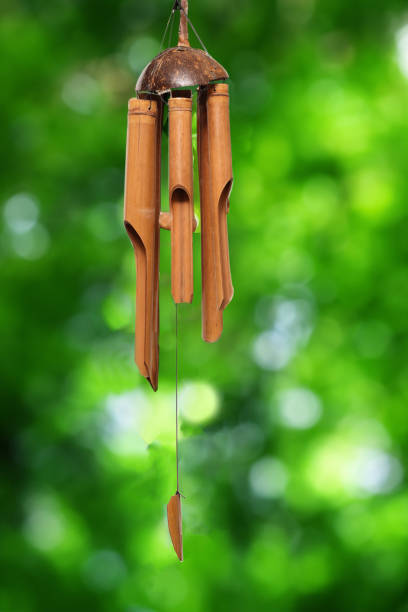 istock Bamboo wind chime isolated on a green background. 1612633971