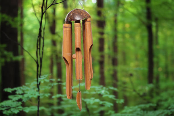istock Bamboo wind chime isolated on a green background. 1612633974