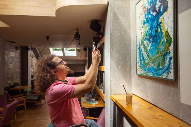 istock Observing a painting at a local cafe 1612644448