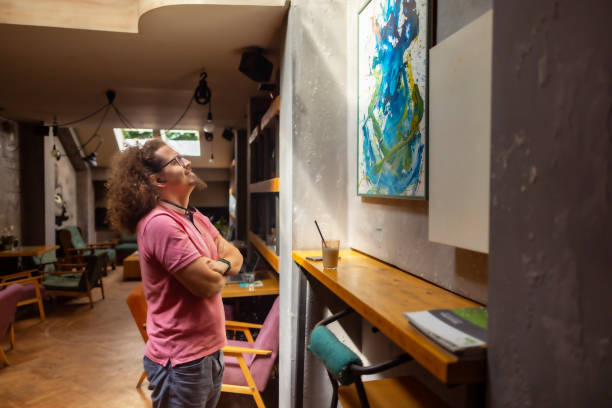 istock Observing a painting at a local cafe 1612644980
