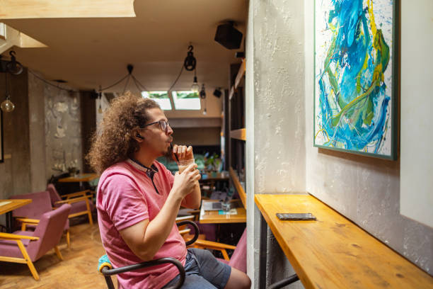 istock Observing a painting at a local cafe 1612646541