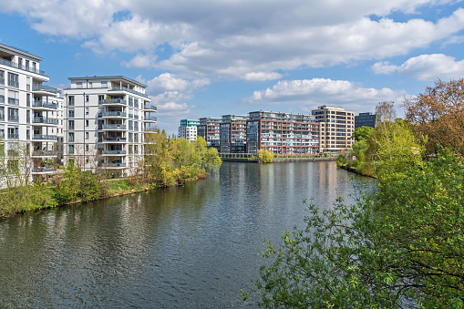 Berlin, Germany - April 28, 2022: Spreekreuz - the waterways crossroad at the southern end of the Charlottenburg Canal, where it meets both the River Spree and the Landwehr Canal with modern residential houses as seen from the bridge Roentgenbruecke