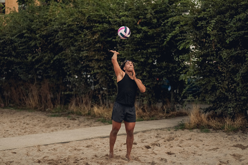 Sports person playing beach volleyball outdoors