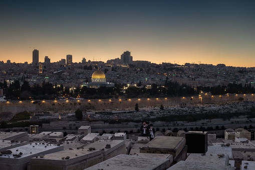Jerusalem, Israel – April 04, 2023: the Jerusalem city featuring a cemetery with many graves, situated in the foreground