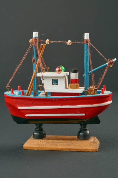 istock Marine Heritage: Spanish Fishing Boat Miniature on Neutral Gray Surface 1612881124