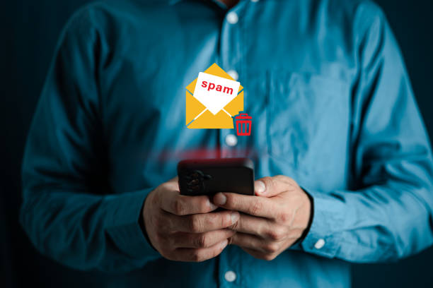 istock Email concept with smart phone spam and virus computer monitor internet security concept, businessman reading electronic mail with a laptop. Spam, junk mail 1612905072
