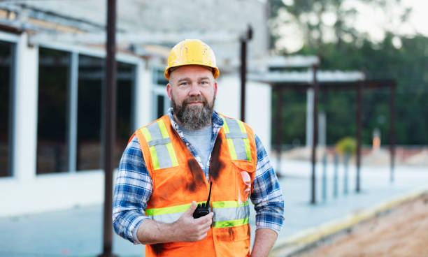 istock Construction worker with walkie-talkie at renovation site 1612926029