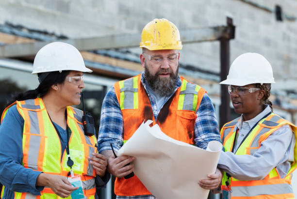 istock Diverse team of three construction workers at job site 1612926575