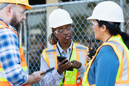 Worker Using Phone Three Construction Workers Meet Using Mobile Phones Stock Photo ...
