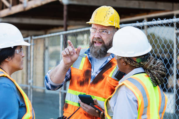 istock Multiracial group of workers meeting at construction site 1612927401