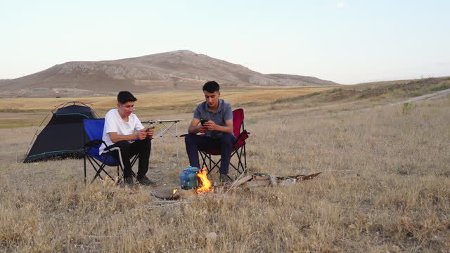 University students camping in the steppe. Young people enjoying camping.