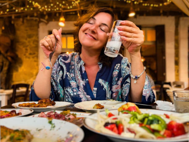 istock Closed eyes happy woman enjoying a drink 1612949392