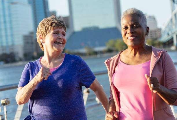 istock Two senior women exercising on city waterfront 1612950947