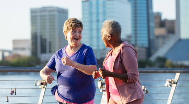 istock Two senior women exercising on city waterfront 1612950948