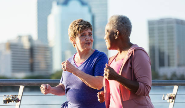 istock Two senior women exercising on city waterfront 1612950950