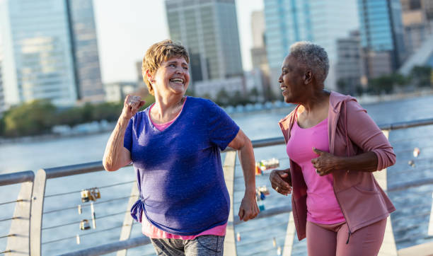 istock Two senior women exercising on city waterfront 1612951458