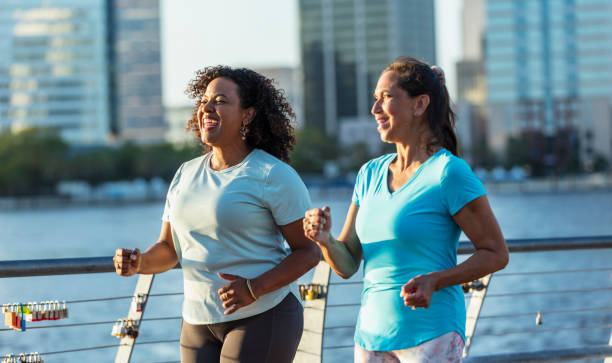 istock Two mature women exercising on city waterfront 1612951484