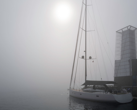 Halifax Harbor sunrise seascape, foggy morning with a moored boat in Nova Scotia, Canada