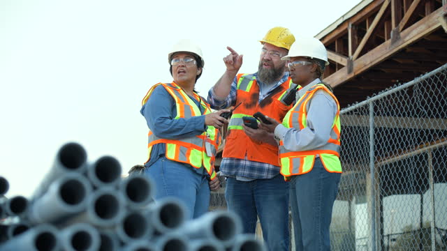 Multiracial group of workers meeting at construction site