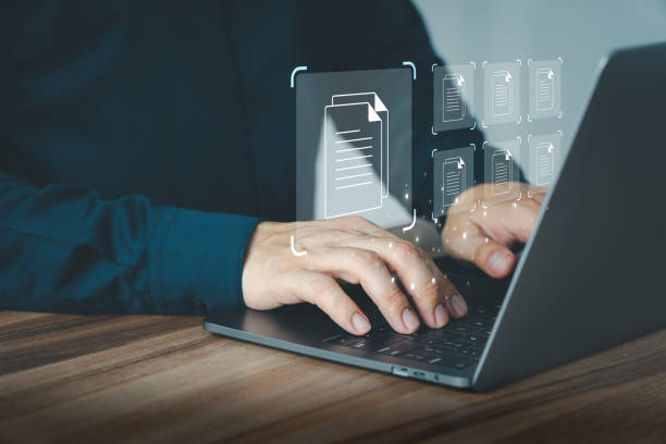 istock Businessman use a computer laptop to manage digital documents, document management concepts, online document database and digital file storage, database technology, and recording software. 1612981604