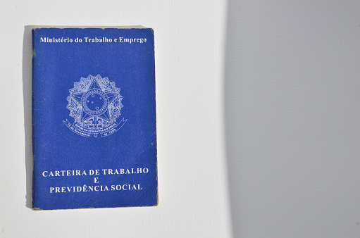Detail of the highlighted Brazilian Employment Card, symbolizing the importance of employment and income for financial stability