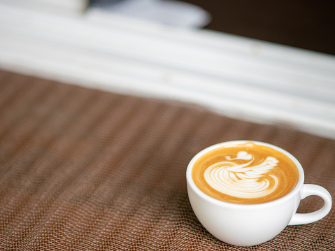 beautiful hot coffee pattern in a white cup