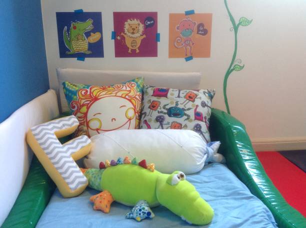 Children's bed decorated in Waldorf style with toys