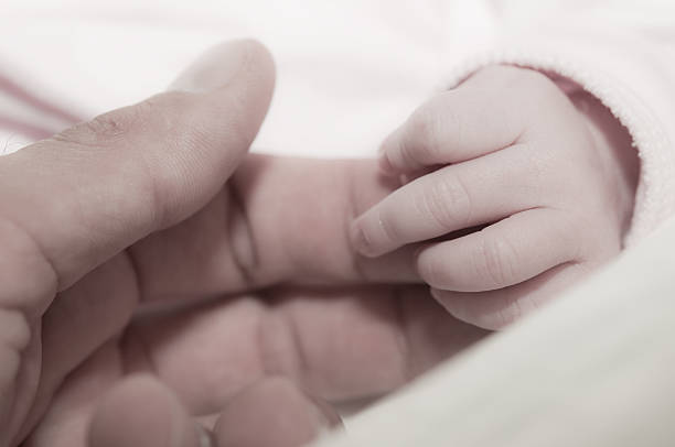 istock new born child's hand 161306987