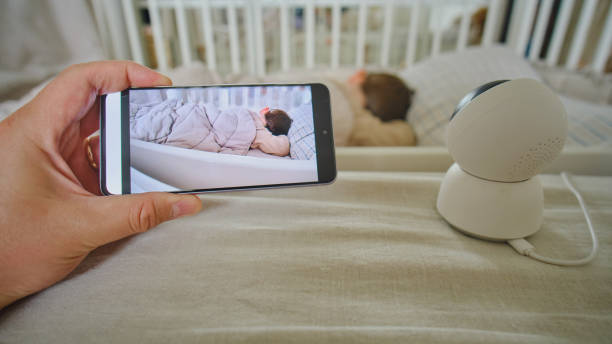 istock Watching a child sleeping in a room from a phone through a camera 1613077580