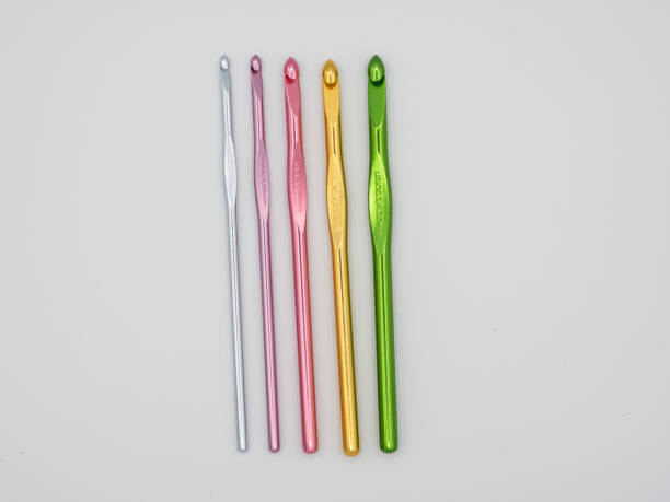 istock Assortment of crochet hooks in various colors isolated on a white background. 1613093628