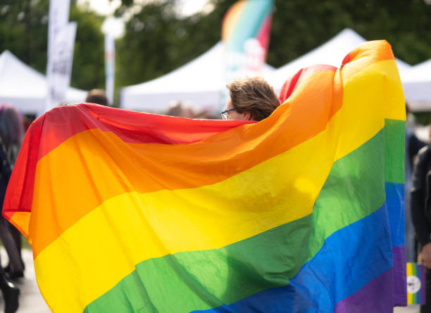 istock A gay man holding large pride flag 1613144400
