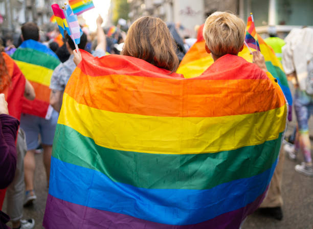 istock LGBT women wearing flags during pride event 1613144403