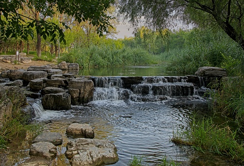 Brook flow trough Beijing Olympic forest park. This park is free of charge and made for as a recreational place for everybody. Because enter to park is free, place i famous for joggers and peoples who like to enjoy a bit nature.