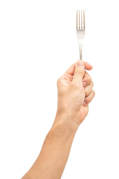 istock isolated of a man's hand holding a silver steel fork. 1613201756