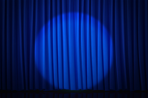Spotlight background with blue curtain reminiscent of a movie theater or stage that can be used to draw attention.