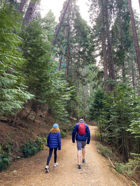 istock A father and daughter walking in a forest 1613207012