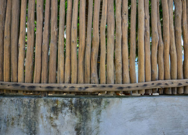 istock Wooden fence with stone wall 1613249380