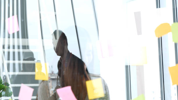 istock Diversity multi ethnic group brainstorming teams with business partner meeting and share ideas in conference room. Creative design colleague talking strategy plan use sticky notes post, present ideas 1613256194