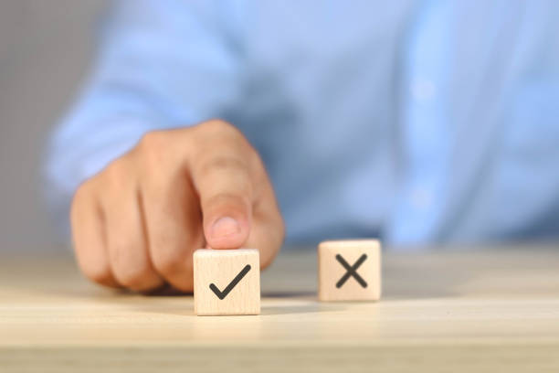 istock Businessman chooses wooden blocks, chooses right and wrong. 1613259378